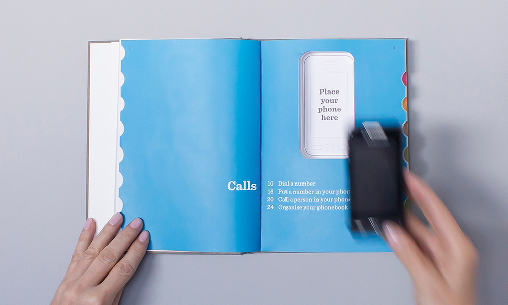 Top view of the manual with a cutout in the middle to slot a mobile phone